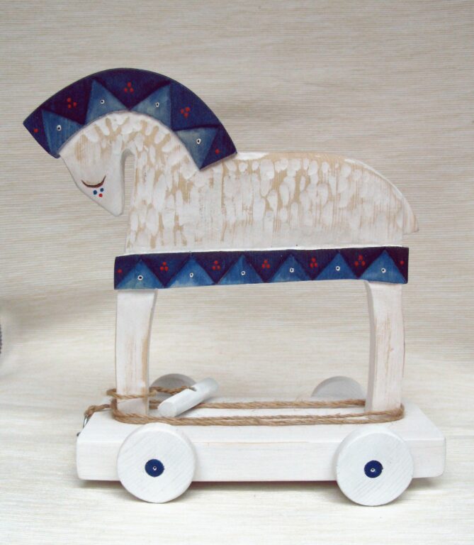 A painted wooden horse on wheels