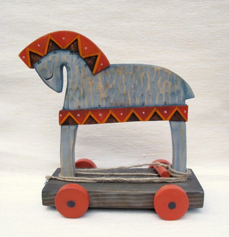 A painted wooden horse on wheels