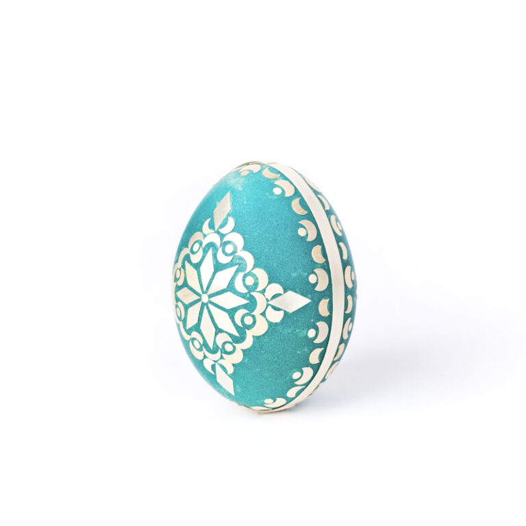 painted egg decorated with straw chicken motif