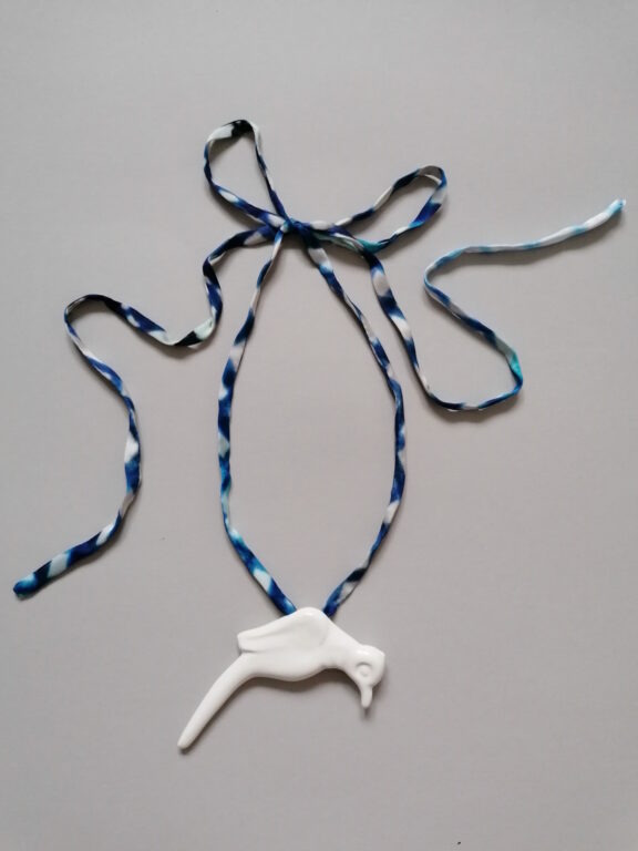 Bird pendant on a ribbon